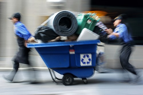 Operatives loading a medium-sized container at an industrial unit